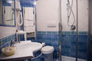 a bathroom with a toilet and a sink and a shower at Residence Panoramic in Maiori