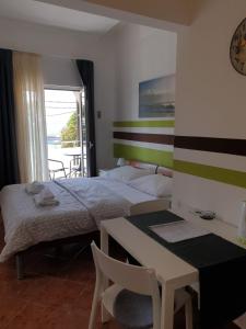 a bedroom with a bed and a desk and a table at Apartments Ivančić in Novi Vinodolski