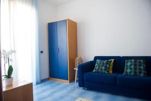 a living room with a blue couch and a cabinet at Residence Panoramic in Maiori