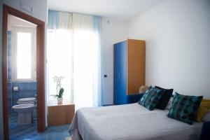 a bedroom with a bed and a bathroom with a toilet at Residence Panoramic in Maiori