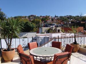 a patio with a table and chairs on a balcony at Casa del Tio Hotel Boutique in San Miguel de Allende