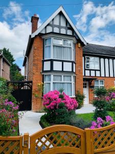 a house with a wooden bench in front of it at Hereward in Wisbech