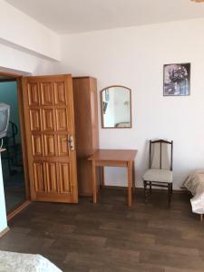 a room with a table and a mirror and a chair at Guest House Livadiya in Livadiya