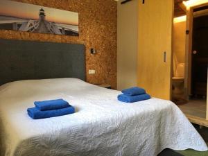 two blue towels sitting on top of a bed at Veeriku Villa in Tartu