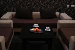 a plate of fruit on a table in a living room at Готель "Палац" in Okhtyrka