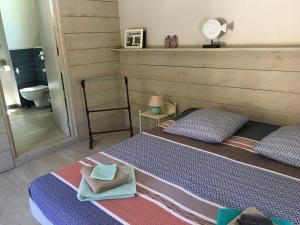 a bedroom with two beds with towels on them at Villa Batelo in Six-Fours-les-Plages
