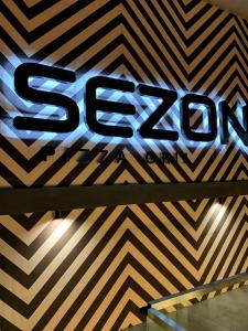 a sign on a wall with a chevron pattern at Sezon in Svityazʼ