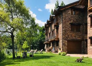 a large brick building with two dogs in the yard at Apartamentos Chuandervera in Laspaúles