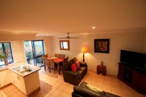 a living room with a couch and a table at Byron Bay Accom Unit 3 41 Childe Street - Belongil Beach Apartment in Byron Bay