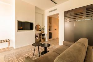 
a living room filled with furniture and a fireplace at Abacus Suites in Ayia Napa
