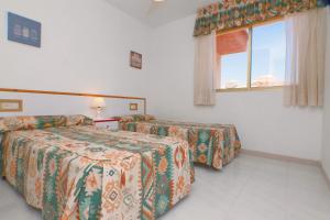 Ein Bett oder Betten in einem Zimmer der Unterkunft Torre Riviera