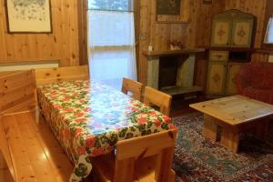 a dining room with a table and chairs and a fireplace at Nevi Apartment in Folgarida