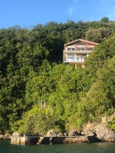 a house on top of a hill next to the water at Kizkitza in Gautegiz Arteaga