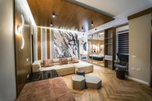a living room with a couch and a mirror at Haris Luxury Apartment no.4 in Tirana