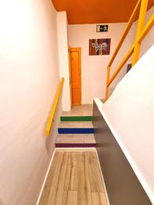 a hallway with stairs with colorful floors and a door at Arc House Gracia in Barcelona
