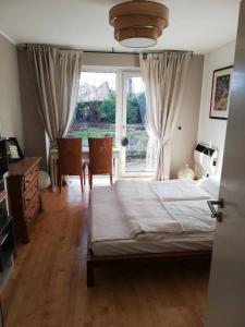 a bedroom with a bed and a large window at Rob´s Place in Langenfeld