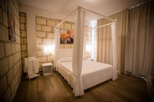 Postel nebo postele na pokoji v ubytování CapoSperone Resort
