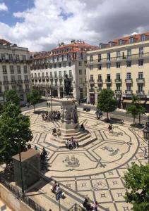 a courtyard with a fountain in front of a building at Bairro Alto Hotel in Lisbon