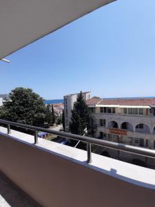 a balcony with a view of a building at Guest House Damyanov in Ravda
