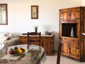 a room with a table with a bowl of fruit on it at Panoramic View Balcón del Atlántico in Adeje