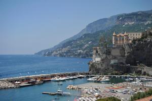 a group of boats in a harbor next to a mountain at Residence Panoramic in Maiori