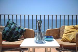 a glass vase sitting on a table on a patio at Residence Panoramic in Maiori