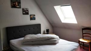 a bedroom with a large bed with a window at Chalet Étoile des neiges in Barèges