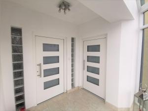 two doors in a room with white walls at LieblingsOrt in Neusiedl am See