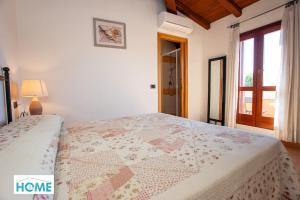 En eller flere senge i et værelse på Villino Tirreno Bilo 1