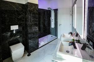 a bathroom with a sink and a shower and a toilet at Escape Luxury Suite - CA Domus Collection in Rome