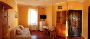 a living room with a couch and a table at Mini Hotel Laza in Lazarevskoye