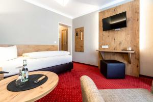 TV a/nebo společenská místnost v ubytování Hotel Vollmann