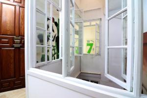 a window with a number seven in it at Feel Hostels City Center in Málaga