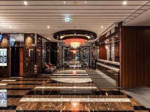 a hallway in a building with a tile floor at APA Hotel Roppongi SIX in Tokyo