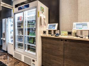 a grocery store with a refrigerator with drinks in it at APA Hotel Roppongi SIX in Tokyo