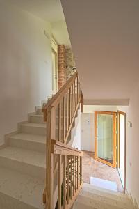 a staircase in a home with a wooden railing at lioelara in Feltre