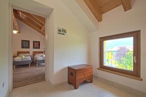 a room with a window and a bedroom with a bed at lioelara in Feltre