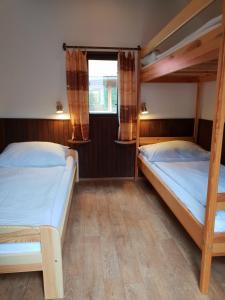 two bunk beds in a room with a window at Chaty U Skály Kytlice in Kytlice