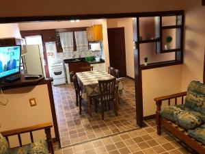 eine Küche und ein Esszimmer mit einem Tisch und Stühlen in der Unterkunft Complejo Casas del Mirador in Barra del Chuy