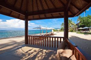 a view of the beach from a porch of a resort at Orlowsky Discovery Candidasa Hotel in Candidasa