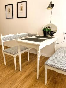 a white table and two chairs in a room at Birdie Home at Nauky metro in Kharkiv