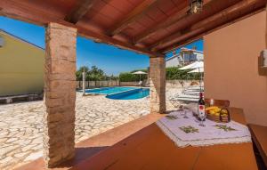 a patio with a table and a swimming pool at Casa Olivia in Kaštelir