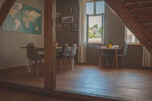 a dining room with a table and chairs and a window at Temple House in Plovdiv