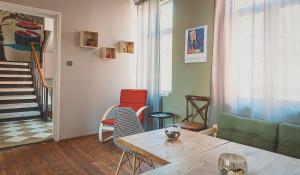 a living room with a table and chairs at Temple House in Plovdiv
