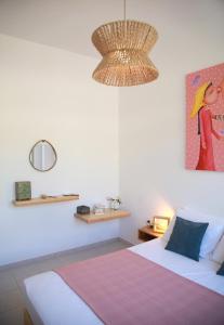 a bedroom with a bed and a chandelier at Bella Mare Sitia in Sitia