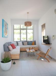 a living room with a couch and a tv at Bella Mare Sitia in Sitia