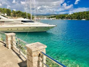 a boat docked at a dock in the water at Apartments Lucy in Milna