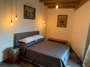 a bedroom with a bed with two pillows on it at Vecchia Posta Casa Vacanze in Montecatini Terme