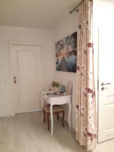 a room with a table and a door with a curtain at Kurpension Meßmer in Tengen