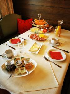 a table with plates of food on top of it at Sportpension Thayer in Piesendorf +36 photos